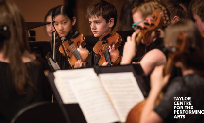 A photo of a few members of the Junior Orchestra performing. Text in bottom right corner reads  Taylor Centre for the Performing Arts.
