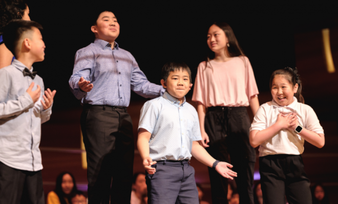 A photo of Speech Arts students performing onstage at the Bella.