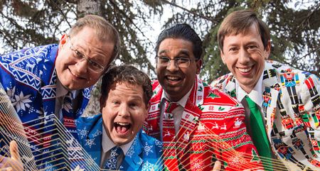 Group photo of the 4 members of the Heebee Jeebees; they are all wearing holiday themed suits.